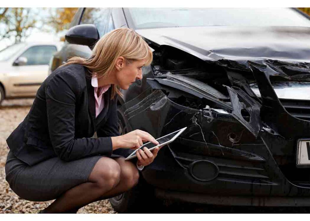 insurance adjuster insurance adjuster looking at damages